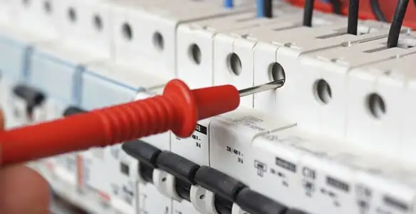 Electrical contractor testing circuit breakers during electrical repair in Latham, NY