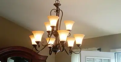 Classic ceiling chandelier installation with warm lighting in Albany, NY
