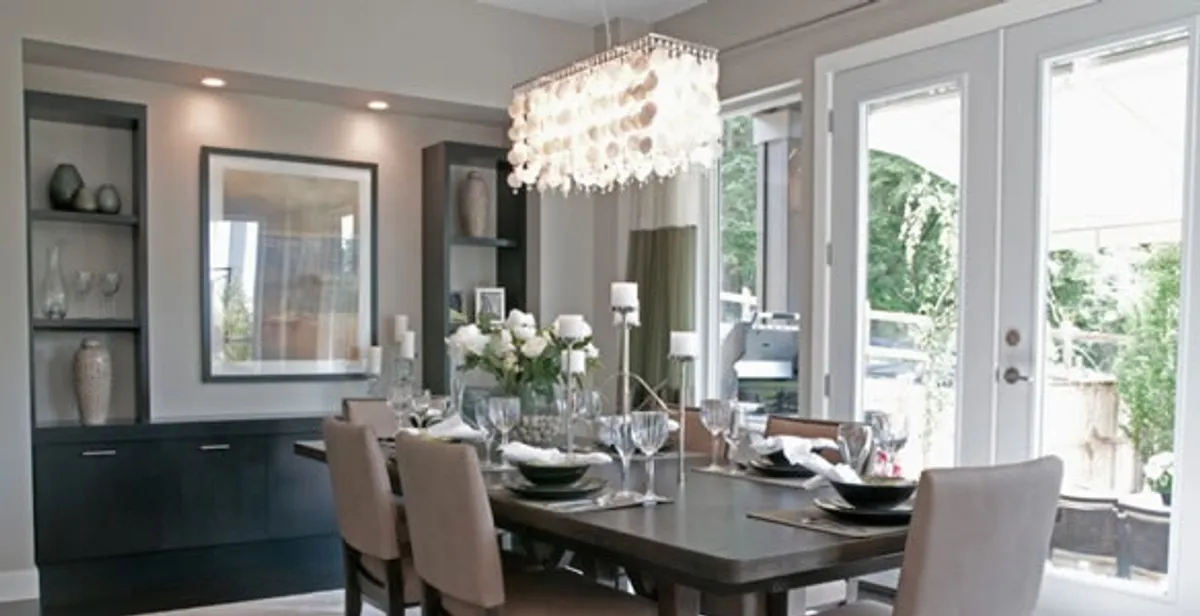 Elegant dining room chandelier installation above table in Albany, NY