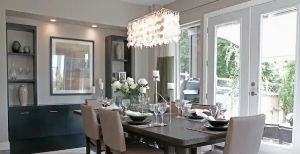 Elegant dining room chandelier installation above table in Albany, NY