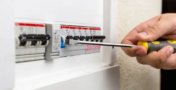 electrical panel upgrade service showing technician adjusting circuit breakers during system upgrade in Albany, NY