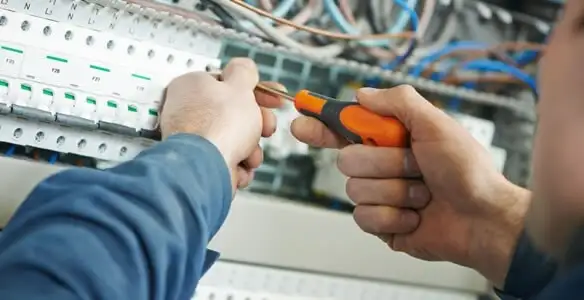 electrical service showing licensed electrician performing electrical panel maintenance and adjustments in Albany, NY