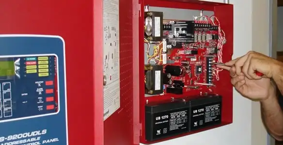 fire alarm installation service showing technician configuring fire alarm control panel in Albany, NY