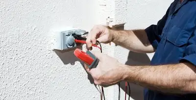 Electrician performing home electrical outlet and wiring inspection in Albany, NY