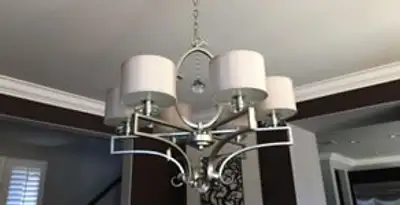Modern chandelier installation with multiple light fixtures in Albany, NY