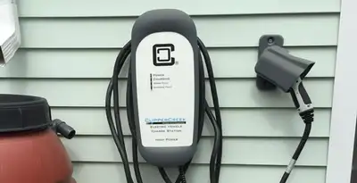Outdoor electric vehicle charger installation on residential wall in Albany, NY