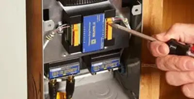 Whole home surge protection device being installed by a licensed electrician to protect electrical systems in Albany, NY